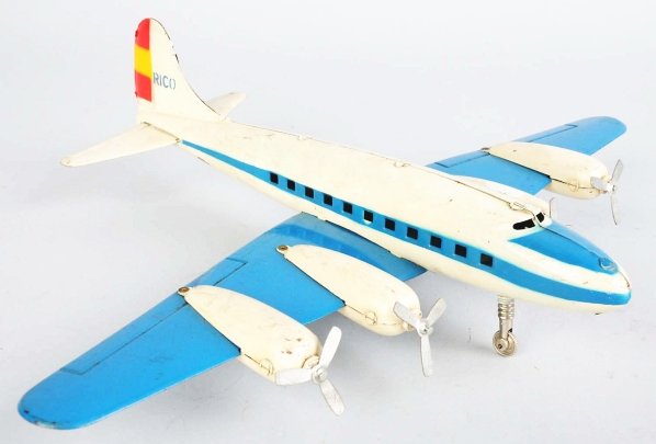 Tin Litho Rico Airplane Friction Toy.: Spanish. Post-war. Working. Airplane is a De Haviland Comet Racer and is a copy of a Douglas DC-4 airplane. Some scratching and wear throughout with one one-inch spot of paint touchup to one engine (p