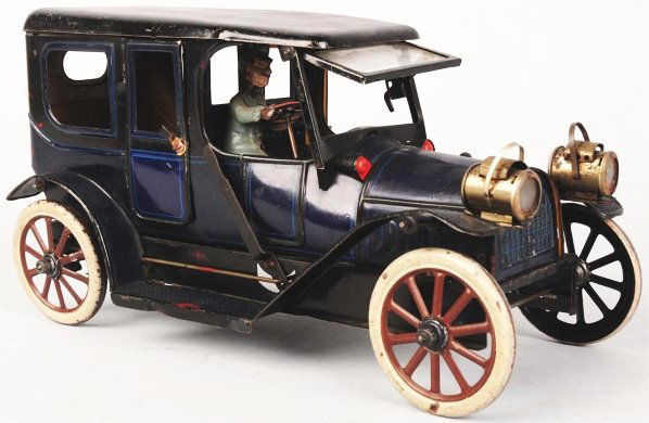 Tin Litho Karl Bub Clockwork Limousine Car.: German. Original driver, headlights, hand brake on right side, and original beveled glass windshield. Some scratching to roof. Condition (Very Good - Excellent). Size 11" L.