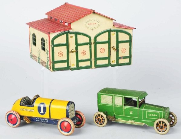 Tin Litho Lehmann Wind-Up Automobile Garage Set.: German. Working. Double garage, marked "Lehmann" with bell mark on rear, includes one original sedan and one original "1" Galop Racer. Some minor scratching and wear to cars and garage and roof tab is