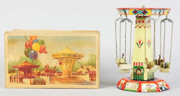 Tin Litho Merry-Go-Round Wind-Up Toy.: German. Working. Marked "Made in Germany". Beautiful color tin litho depicts six people riding in carts that move around tower. Minor scratching and wear overall. Includes original box with nice color