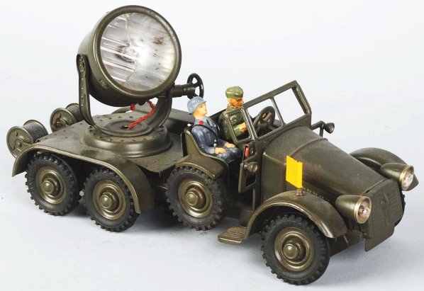 Lineol Clockwork Hausser Searchlight Truck.: Working. Tin litho. Includes driver and passenger. Lens is cracked. Condition (Excellent).