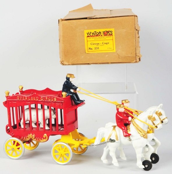 Cast Iron Kenton No. 231 Circus-Cage Wagon Toy.: American. Pulled by two horses. Toy is in unused condition. Includes original box with paper label and marked "Kenton Hardware Company Ohio". Box has some creasing and slight tearing. Condition (Near