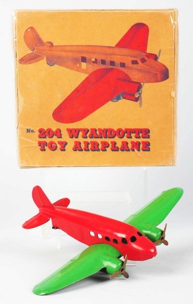 Pressed Steel Wyandotte Airplane Toy.: American. White rubber tires are slightly wobbly. Airplane has some minor paint chipping and wear. Includes scarce original box marked "No. 204 Wyandotte Toy Airplane". Box has some creasing and teari