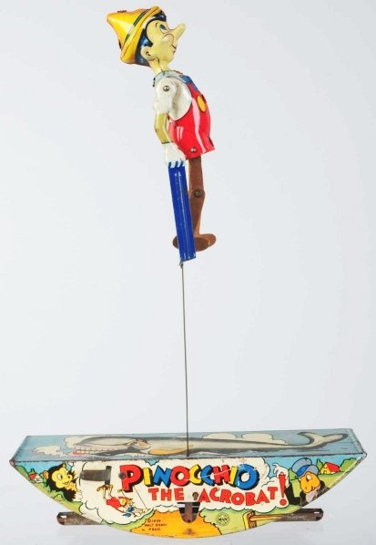 Tin Litho Marx Pinocchio Acrobat Wind-Up Toy.: American. Working. Marked "1939 Walt Disney Prod." on base and has lithographed Pinocchio characters on base as well. Some scratching and wear throughout. Condition (Very Good). Size 16 - 1/2" T.