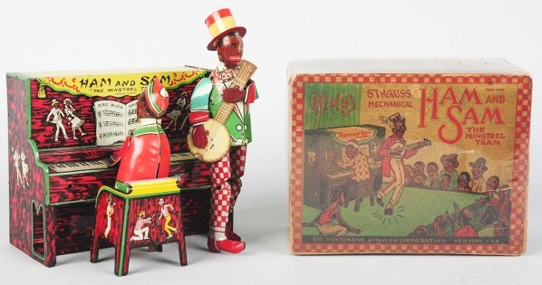 Tin Strauss Ham & Sam Minstrel Band Wind-Up Toy.: American. Working. All original. Some scratching underneath of arms and in banjo area. Includes original box with some creasing and tearing. Box is wrapped in plastic for protection. Condition (Very G