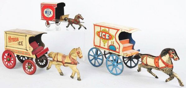 Lot of 3: Tin Horse-Drawn Pull Toys.: American. Circa early 20th century. Includes two ice wagons (one Hygeia) and one milk wagon. Nice lithography throughout with just some scratching and wear. Condition (Very Good). Size Largest: 14 - 1