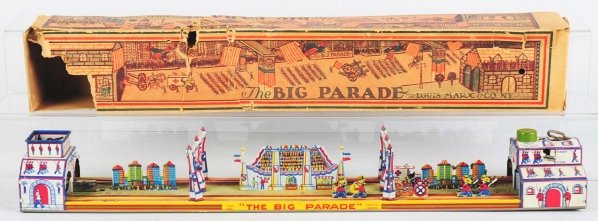 Tin Litho Marx Big Parade Wind-Up Toy.: American. Working. Toy is missing its airplane but has very little wear. Includes partial original box with some tearing and creasing. Condition Toy (Excellent) Box (Good). Size 24" L.