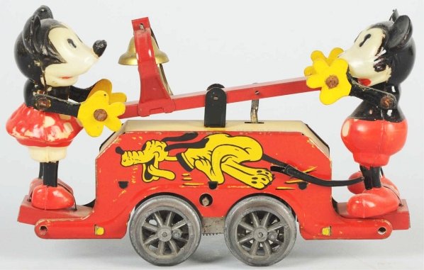 Wells Disney Mickey & Minnie Clockwork Handcar.: English. Marked "Made in England" on top. Celluloid figures with nice lithography around base. Mickey's nose is missing and Minnie's skirt has one crack. Also, some minor scratching and wear throughou