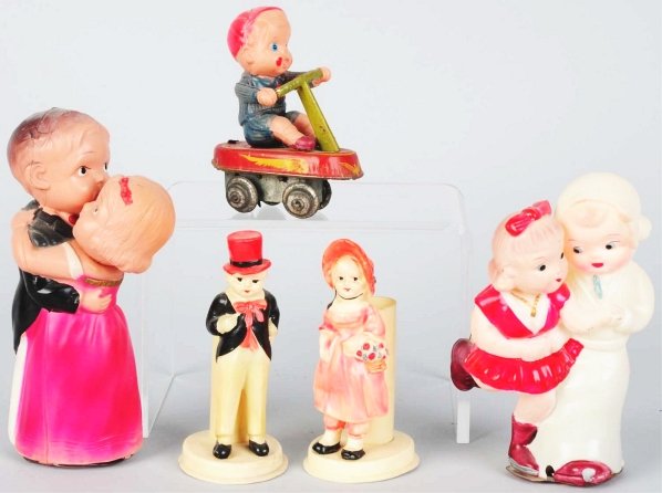 Lot of 5: Celluloid Figural & Wind-Up Toys.: Japanese. Includes one man figural toy and one woman figural toy. Wind-up toys include one boy on scooter, one dancing couple, and one ice skating couple. Some slight splitting and denting. Various co