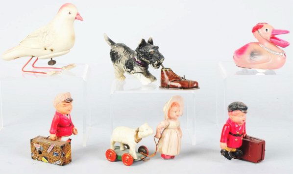 Lot of 6: Celluloid Wind-Up Toys.: Japanese. Includes three animal toys, two suitcase Porter toys, and one Mary with her Little Lamb toy. Mary is missing her tin platform with mechanism. Some splitting to celluloid. Condition (Very Goo