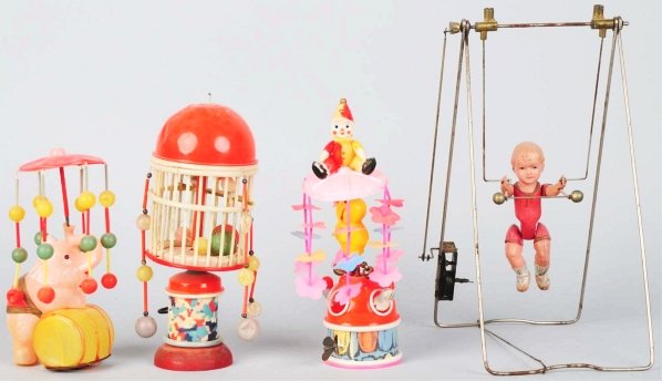 Lot of 4: Celluloid Animal & Figural Wind-Up Toys: Japanese. Working. Includes three whirligigs consisting of one elephant, one cage, and one go-around, along with one acrobat toy on tin frame. Various conditions. Condition (Very Good). Size Largest: 