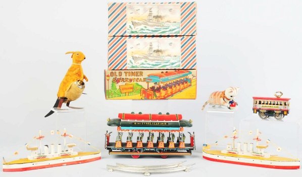 Lot of 6: Miscellaneous Toys.: Japanese. Includes one friction street car and two wooden battleship boats. Also includes one wind-up cat, one wind-up electric trolley car, and one fur-covered kangaroo. Various conditions. Includes 