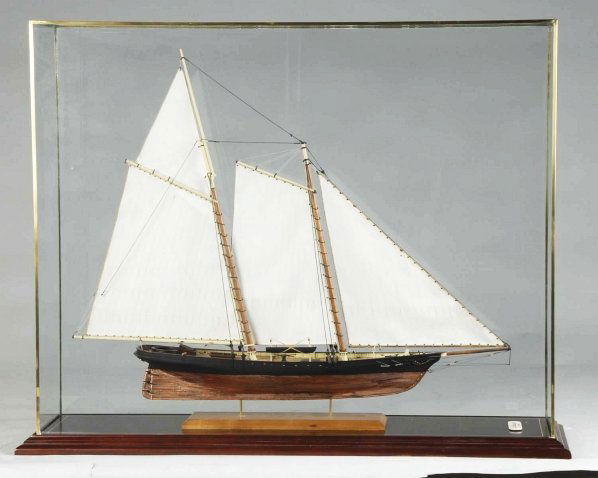 1851 Racing Yacht "America" Model.: Built by J. Sotham. Plank-on-frame construction with copper sheathing below waterline and properly rigged with sails and correct deck details. Condition (Near Mint). Size Case: 43" x 13" x 33".