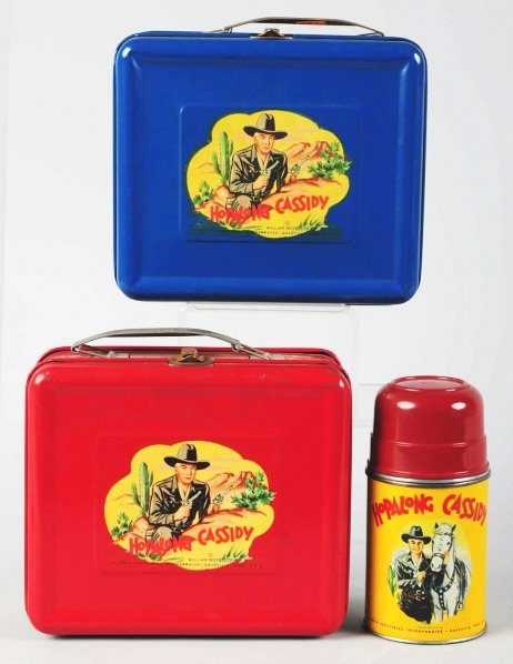 Lot of 2: Tin Litho Hopalong Cassidy Lunch Boxes.: Circa 1951 to 1953. Marked "William Boyd Ltd.". Both with nice decals of Hopalong Cassidy, one in blue and one in red. Includes one thermos. Some minor scratching and play wear. Condition (Excellent).
