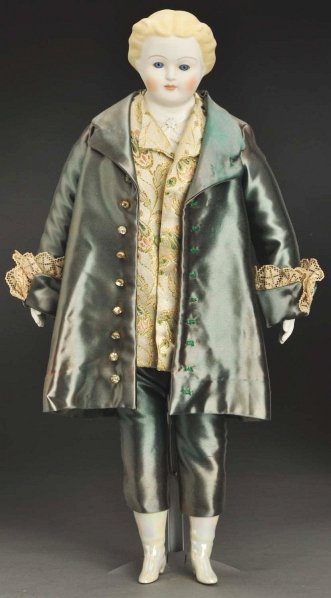 Emma Clear Parian Doll.: Shoulder head signed “Clear” on back with molded collar and tie, molded short blonde hair, long stroked eyebrows, inset glass eyes, painted upper and lower eyelashes, closed mouth, rosy cheeks; or