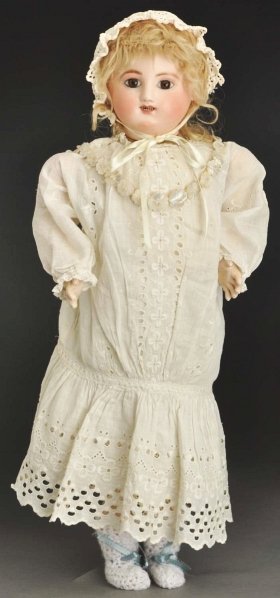 French Steiner Gigoteur Doll.: Crying, kicking Bébé with bisque head made by Jules Steiner in Paris, multi-stroked eyebrows, mauve eye shadow, inset brown glass eyes, delicately painted upper and lower eyelashes, open mouth with 