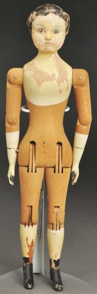 Wood Joel Ellis Doll.: American wood doll made in Vermont, Ca. 1873 with carved face and molded black hair (lots of paint peeling as is usual, touch-up also); original jointed wooden body, metal hands and feet. Condition (F