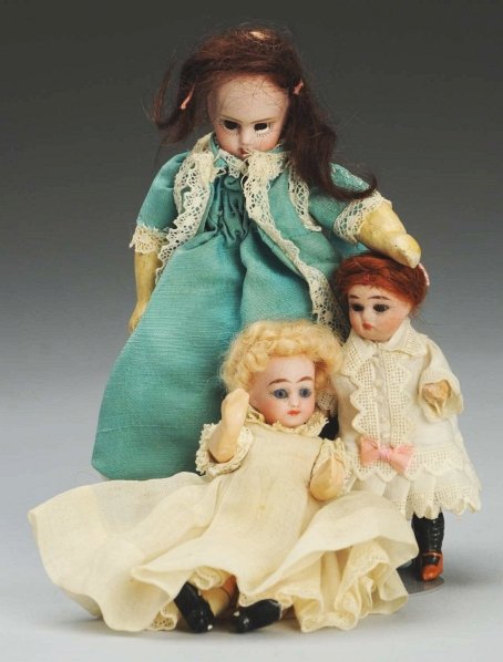 Lot of 3 German Bisque Dolls.: All with bisque socket heads, glass eyes, open mouths, wigs and 5-piece composition bodies. French girl with Anchor mark (plaster showing on her eye socket needs to be scraped off), 2 German girls are