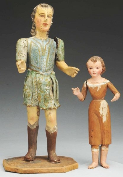 Lot of 2 Santos Religious Figures.: Carved wood male figure with dark carved hair that has a plaster coating in some spots which is partially worn off, serene face with prominent nose, carved eye sockets with inset eyes; garment is pain