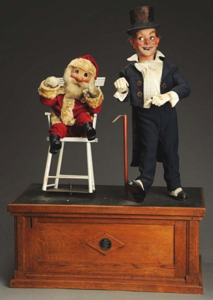 Early Composition Santa Claus Automaton.: French. Electric plug-in. Glass eyes and cloth clothing. Depicts man with top hat, standing next to Santa Claus whom is sitting in a rocking chair. Wooden box is heavy. Some line cracking to hands of 