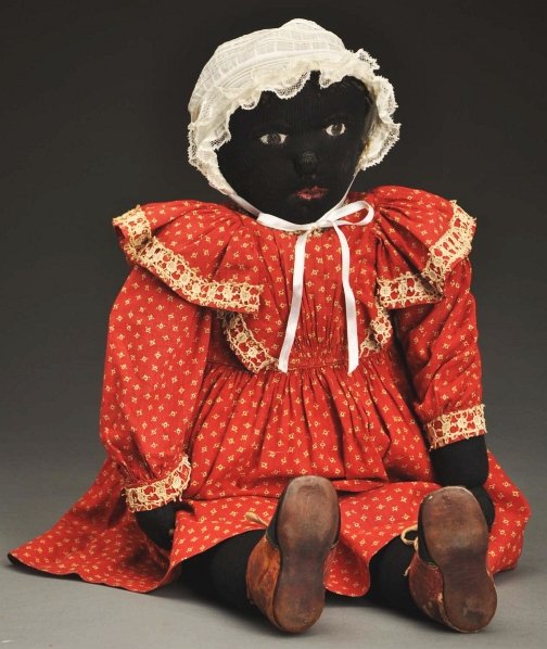 Very Rare Black Missionary Ragbaby.: Made by Julia Beecher of Elmira, NY, Ca. 1900. Black stockinette with needle sculpted face (holes in cheek and nose), painted eyes and mouth, looped wool hair (mostly gone), stitched ears; chubby body