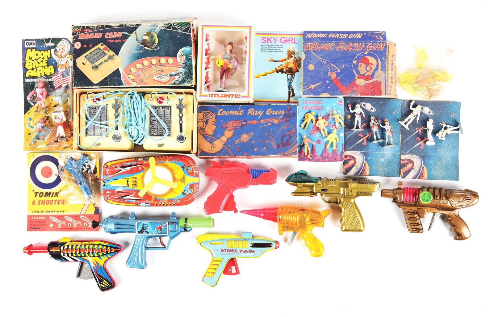 NICE LOT OF VARIOUS TIN LITHO & PLASTIC SPACE GUNS, VEHICLES & FIGURES.: Some in the original boxes. Includes Morse code machine, atomic flash pistol, comic ray gun, interesting plastic ray guns, some box and carded plastic figures and tin litho and plastic space ship. Con