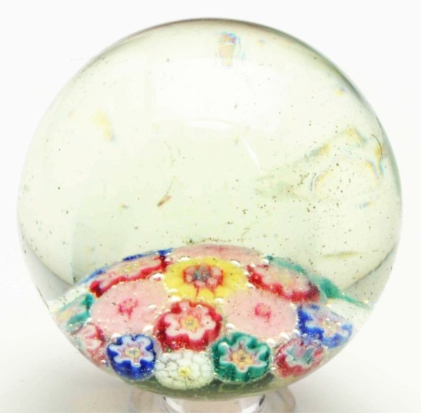 Single Pontil Millefiori Marble.: Beautiful colors of pink, yellow, red, blue, and green. This marble has been buffed with some damage still showing. Pontil is intact. Condition (Buffed). Size 1 - 5/8" Dia.
