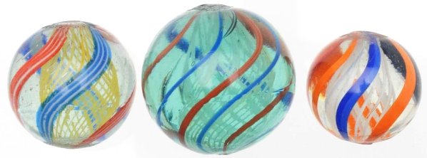 Lot of 3: Latticino Swirl Marbles.: The smallest is white latticino with bright orange, red, blue, and black outer bands. The largest marble is a white latticino in light Dutch blue tinted glass. Outer bands are blue alternating with re