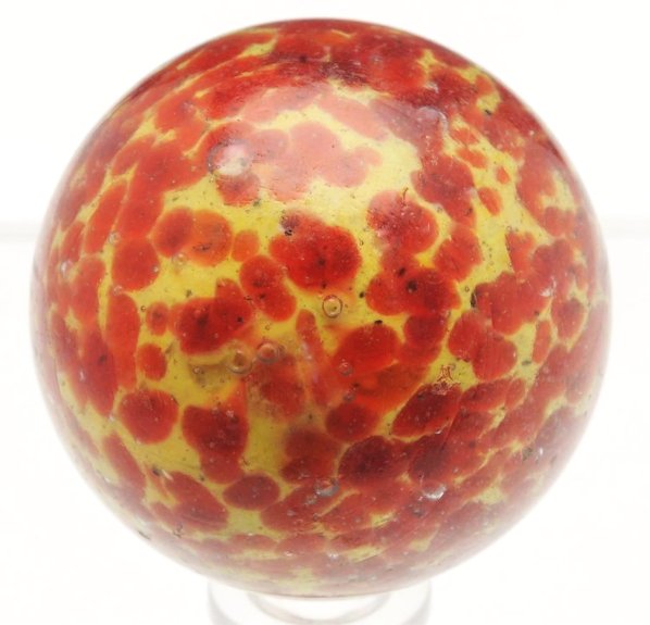 Large Single Pontil End of Day Marble.: Yellow base marble with great even spotting in red. Minor reflections and several minor chips. Condition (8.8). Size 1 - 7/8" Dia.