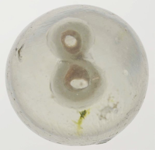 Number 8 Sulphide Marble.: Good detail and well-centered number "8" figure. Slight bubble to back of figure and a wisp of green in the transparent body glass. This marble has several surface chips. Condition (8.6). Size 1 - 19/