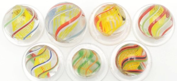 Lot of 7: Latticino Swirl Marbles.: Includes seven yellow latticino swirls with multicolored outer decorations. Condition (9.5 - 9.8). Size Range: 1/2" to 11/16" Dia.