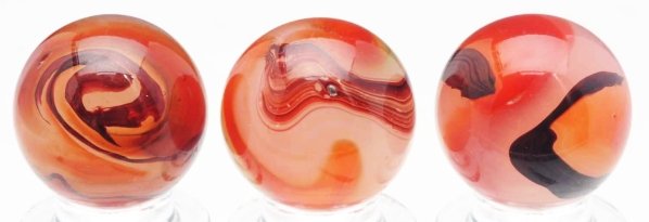 Lot of 3: Akro Agate Cornelian Oxblood Marbles.: Includes three beautiful cornelian oxbloods, all with nice and heavy oxblood pattern. Some as-made surface indentations and one marble has as-made debris embedded in surface. Condition (9.6). Size Eac