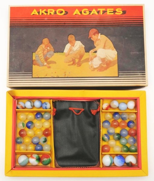 Akro Agate No. 250 Marble Box Set.: Box set contains 54 marbles consisting of mostly patches moss Agates and tri-color patch marbles. Box has an original Akro bag, box top is in excellent condition, and box bottom has some bending. Cond