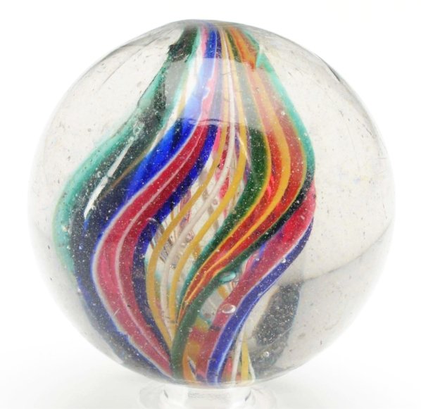 Complex Naked Ribbon Core Swirl Marble.: Ribbon center is made up of white and yellow latticino threads capped on one side with a ribbon in cobalt, white, and red and the other side capped with red, yellow, and green. Each ribbon is identica