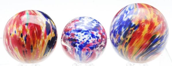 Lot of 3: Handmade Marbles.: Includes one four-paneled onionskin with white base and two opposing panels of cobalt/yellow/white and two opposing panels of red/yellow/blue. This marble has been polished, causing it to lose its pon