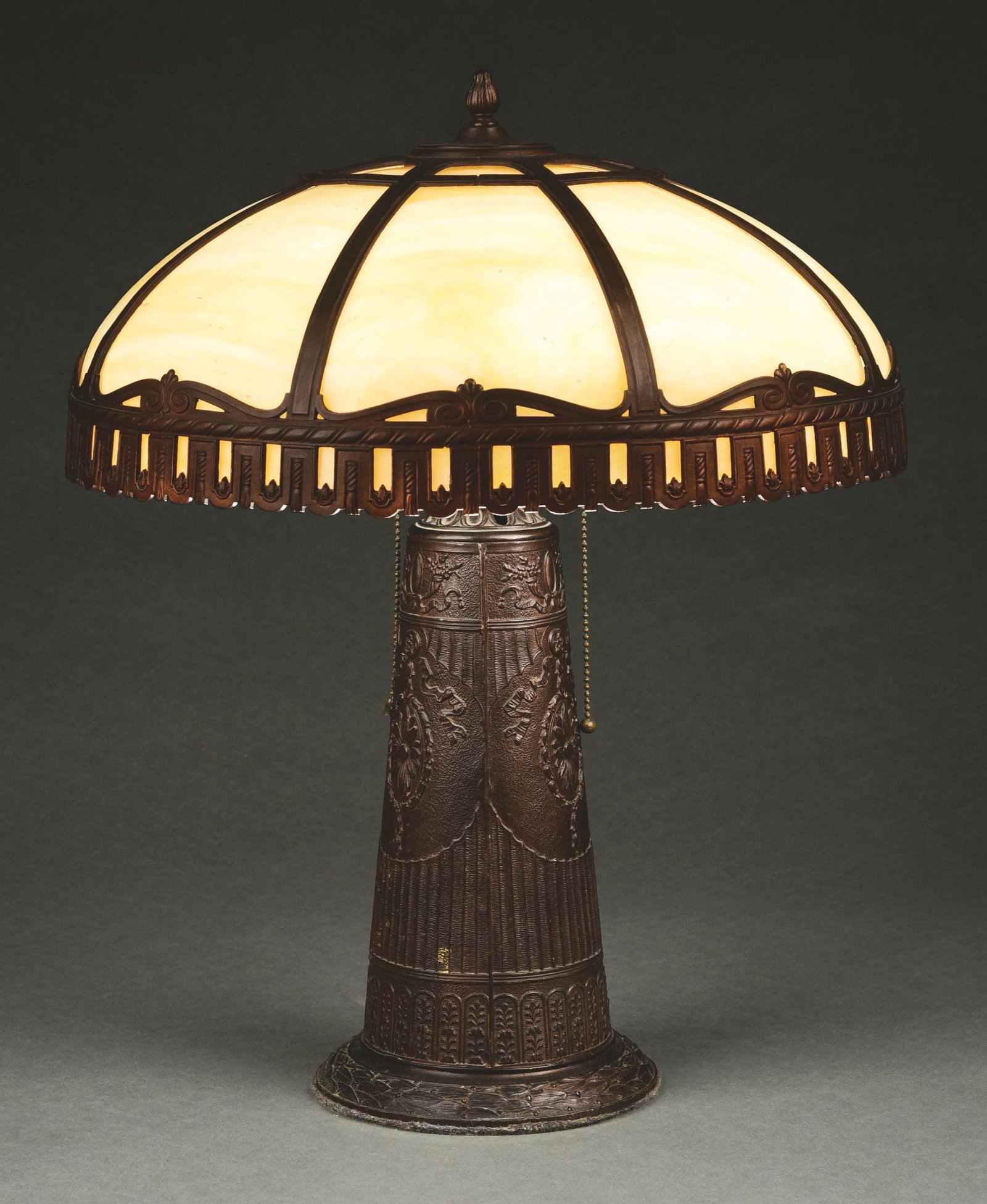 SLAG GLASS BRONZE LAMP.: Slag glass shade with bronze base in very good condition. One panel has multiple hairline cracks, otherwise no breaks to the glass. The base is in excellent condition with only a few small scratches t