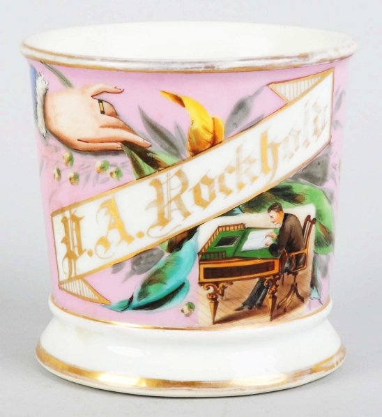 Bookkeeper Shaving Mug.: Gilt name "P.A. Rockhold". Nice detailed image of a man working on a ledger. Pink wrap. Condition (Excellent). Size 3 - 1/2" T.