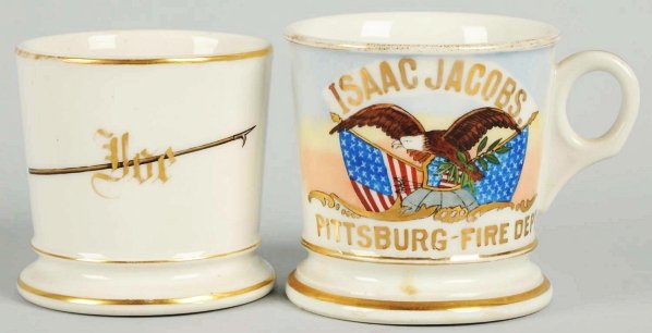 Lot of 2: Shaving Mugs.: Includes one fraternal shaving mug with gilt name "Isaac Jacobs" and one fireman's spear mug with gilt name "Joe". Condition (Excellent). Size Largest: 3 - 3/4.
