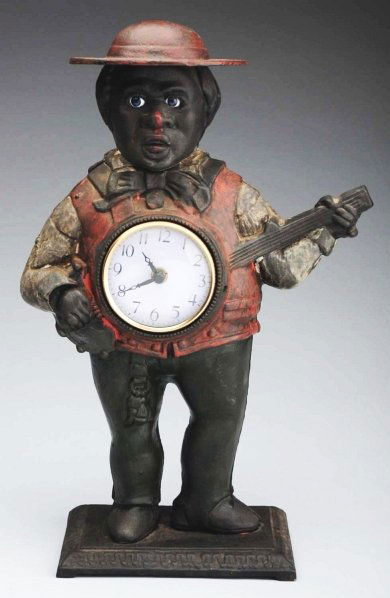 Cast iron Banjo Player Moving Eye Clock.: Later casting. Replaced clock. Condition (Excellent). Size 15" T.
