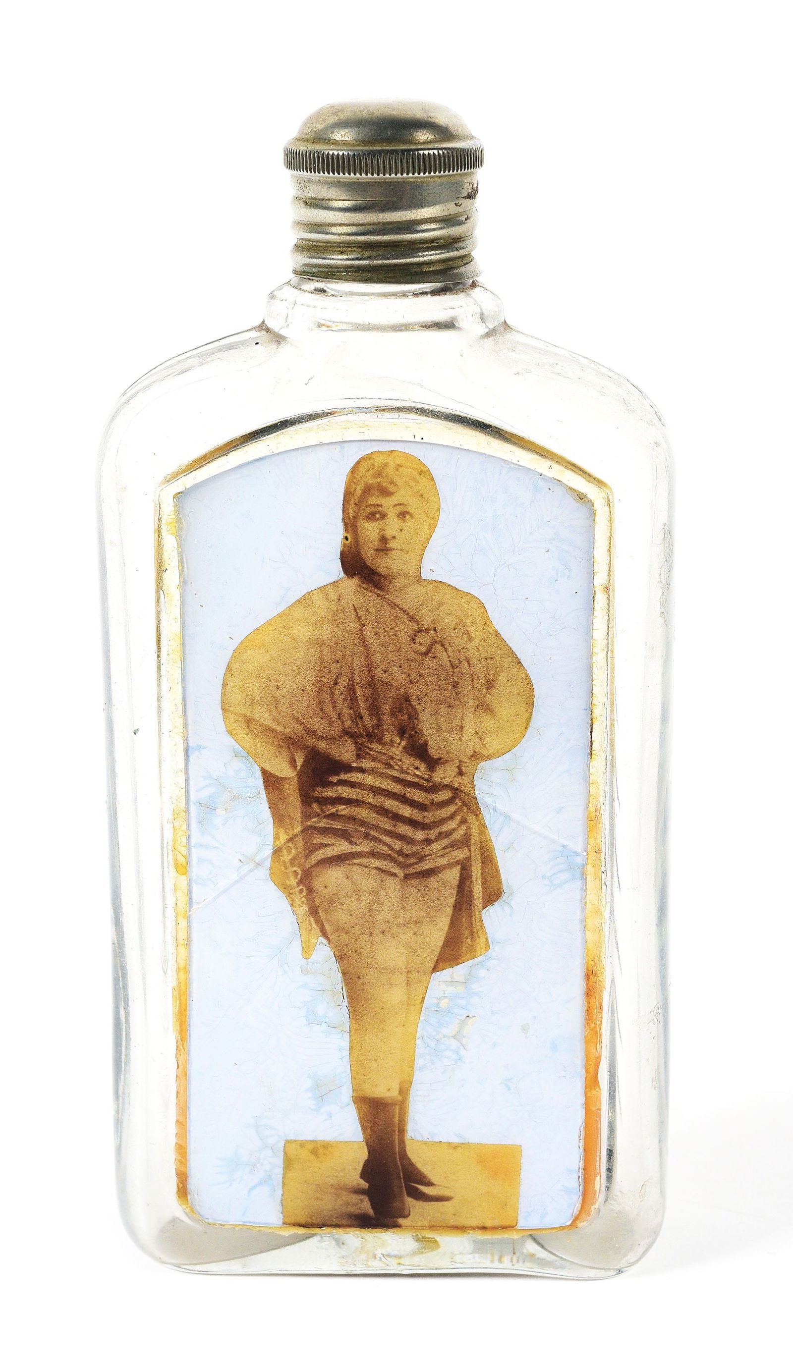 REVERSE ON GLASS WHISKEY FLASK.: A nice photographic image of girl. Small hairline crack on front of glass. Original silver cap.