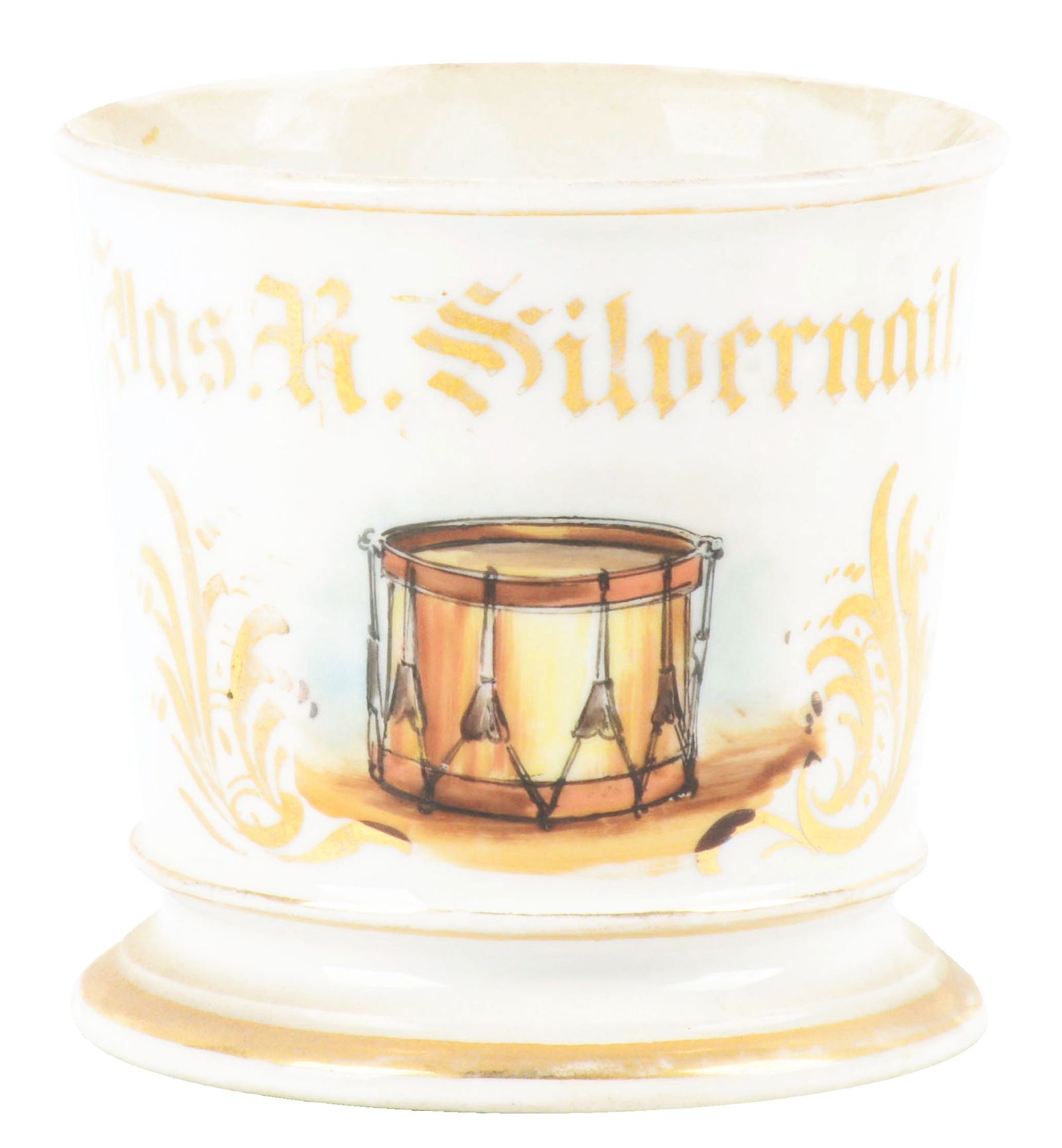 DRUMMER SHAVING MUG.: Jazz R. Silvernail in gold gilt. Mug is stamped "T&V Limoges France" under the base. Beautiful image of snare drum. Condition: (Excellent). Dimensions: 4 - 1/2" x 3 - 3/4" x 3 - 1/2".