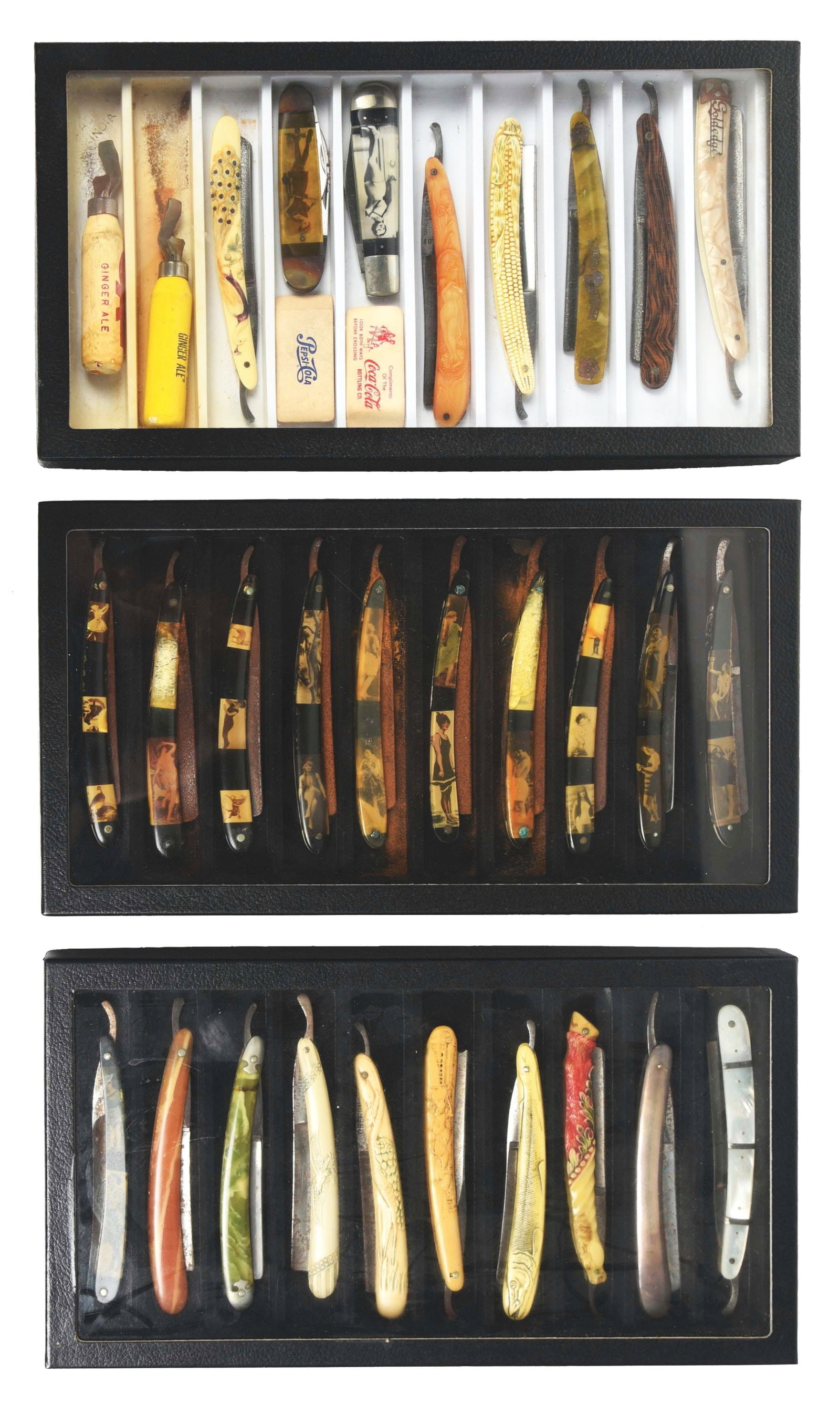 COLLECTION OF 3: BARBERSHOP STRAIGHT RAZORS HOUSED IN SHADOWBOXES.: A fantastic collection of barbershop straight razors. Many bone and celluloid handles. Some with pretty girls from multiple manufacturers. Includes two girly pocket knives. Condition: (7.0 - 9.0). Dim
