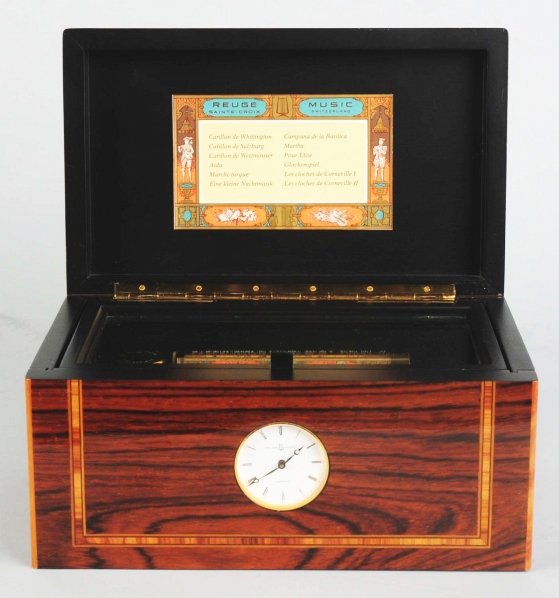Reuge Quartz Movement Clock with Music Box.: Plays one of 12 tunes on the hour or manually. Condition (Excellent). Size 9" L.