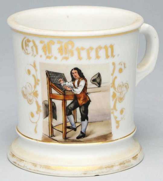 Typesetter Shaving Mug.: Gilt name "CD. F. Green". Stamped "Germany" and artist signed "BASS" under base. Nice and detailed image of a man working on a typeset rack. Some wear to gilding. Condition (Excellent). Size 3 - 3/4" 