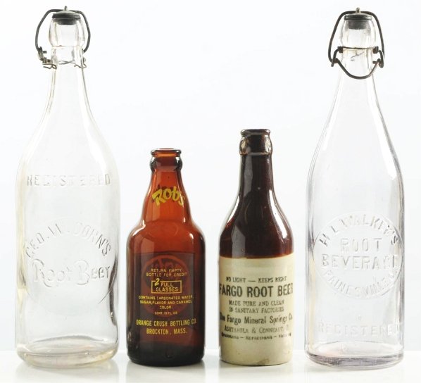 Lot of 4: Root Beer Bottles.: Dorn’s and Walker’s clear quarts with closures remaining and little wear, Rob’s ACL, and stoneware Fargo with a few nicks and two base chips. Condition (Excellent - Near Mint). Size Largest: 11 