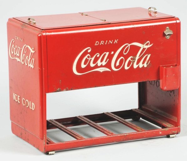 1939 Coca-Cola Salesman's Sample Cooler.: Missing the lid gasket and displaying reproduction books under lid. Body is sound with stains, surface rust, paint wear. Condition (Very Good). Size 10" x 12".
