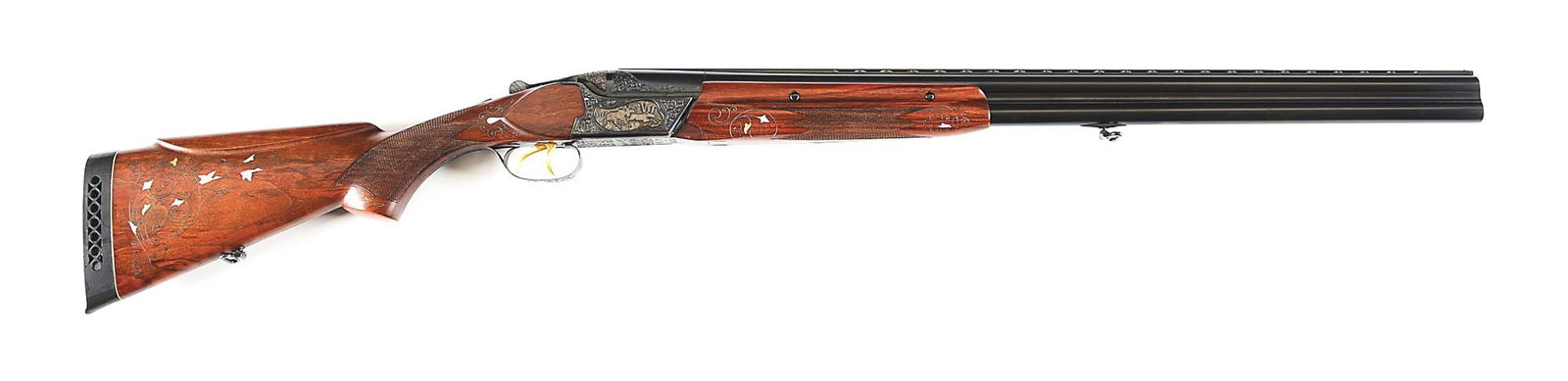 (M) A HIGH GRADE SOVIET ERA BAIKAL OVER/UNDER 12 GAUGE SHOTGUN.: Made in the USSR at Tula circa the 1980s. 28" round blued barrels with ventilated rib, fixed Full and Full chokes, bead front sight, and 2 - 3/4" chambers with floral engraved breeches. Matching blued