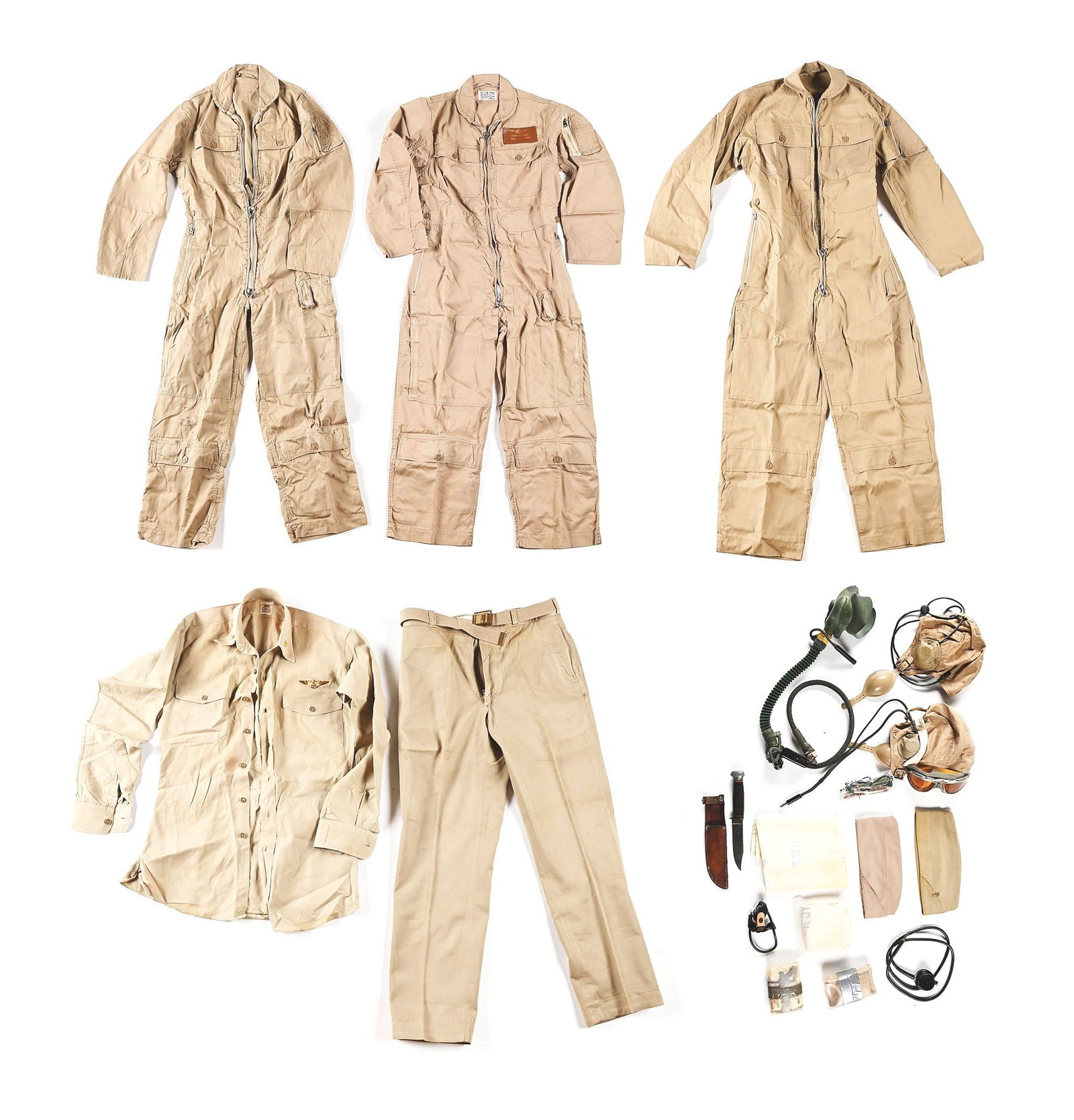LOT OF US WWII NAVAL AND MARINE AVIATOR UNIFORMS AND EQUIPMENT.: Lot consists of: 3 MIL-S-5390B flight suits (Korean War era) sized 36 Long, 36 Medium, and 38 Medium. 38 medium suit has a leather name tag named to "JOHN M. STOKES / ENS. USNR". Suits are clean, with