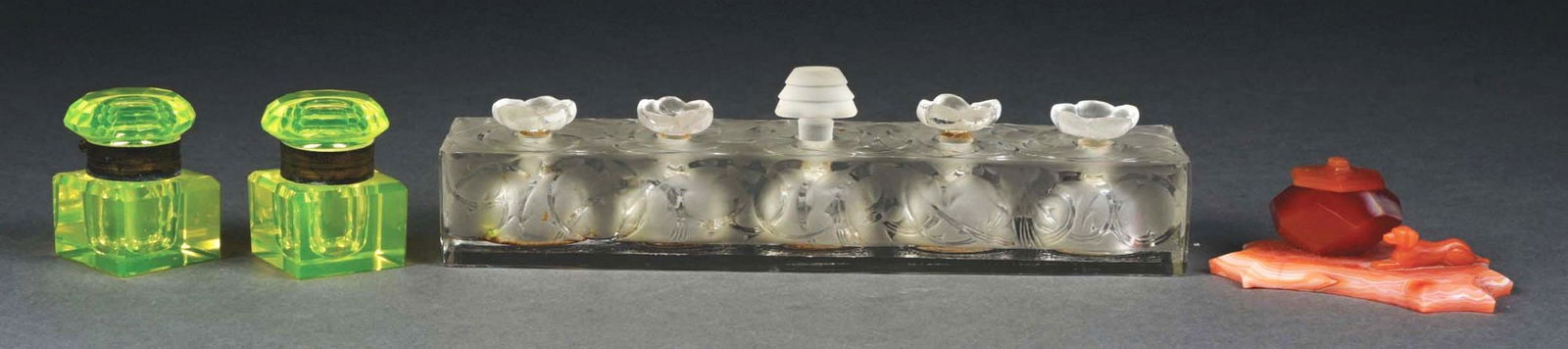LOT OF 4: INKWELLS & A PERFUME SAMPLER.: (A) L'Oreal five perfume bottle sampler, Lalique design, unsigned, middle stopper is a replacement. 9" long, 2" tall and 2" wide. No chips or cracks. (B & C) Pair of Vaseline glass inkwells with hinge