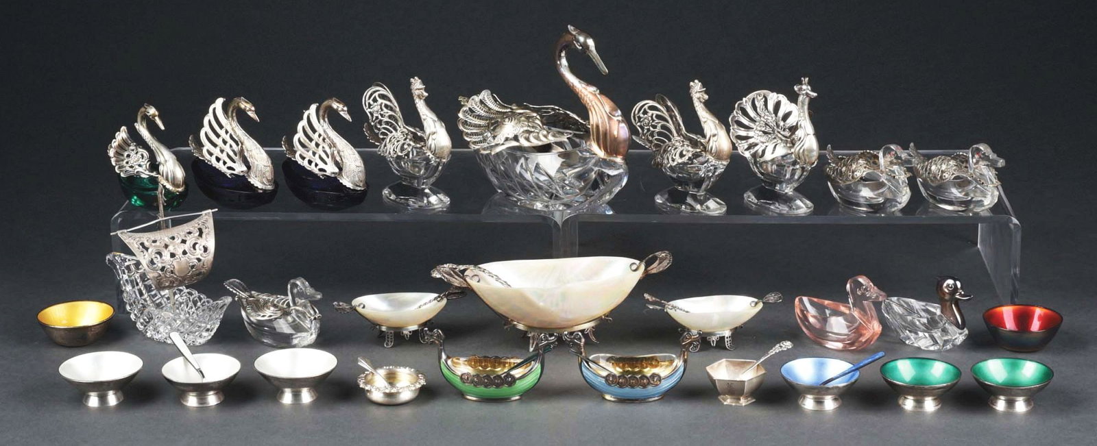 LOT OF OVER 25 ANTIQUE SALTS & SPOON PIECES: Lot includes four swans, two roosters, sailing ship, peacock, five ducks, two enameled Viking ships, eight enameled salts, Morton salt with shell and silver holder and two smaller shell salts. Most wi
